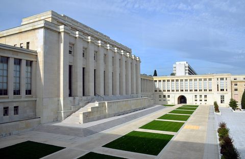 The Palais des Nations, Geneva: a pale stone building with a stepped terrace and lawns in front