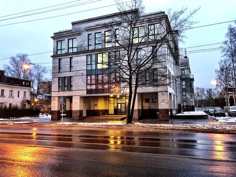 The building at 55 Savushkina Street, St Petersburg, photographed from the street on a wet evening in winter