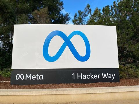 Entrance sign at Meta's headquarters complex in Menlo Park, California, reading Meta, 1 Hacker Way