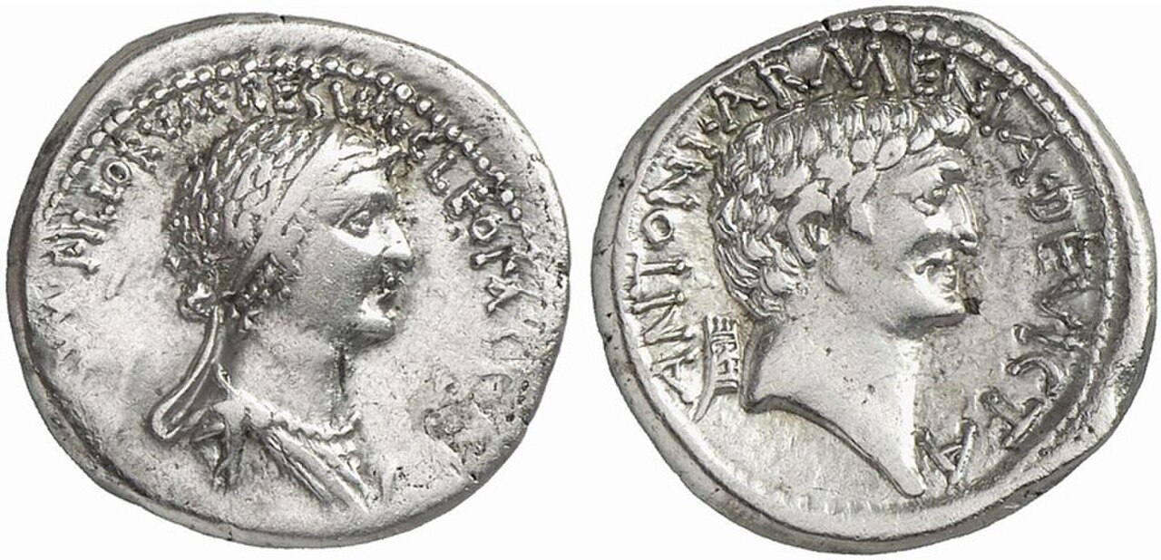 Silver denarius: on the left, a portrait of Cleopatra with a Latin legend naming her queen of kings; on the right, a portrait of Mark Antony with the legend ANTONI ARMENIA DEVICTA and an Armenian tiara behind his head