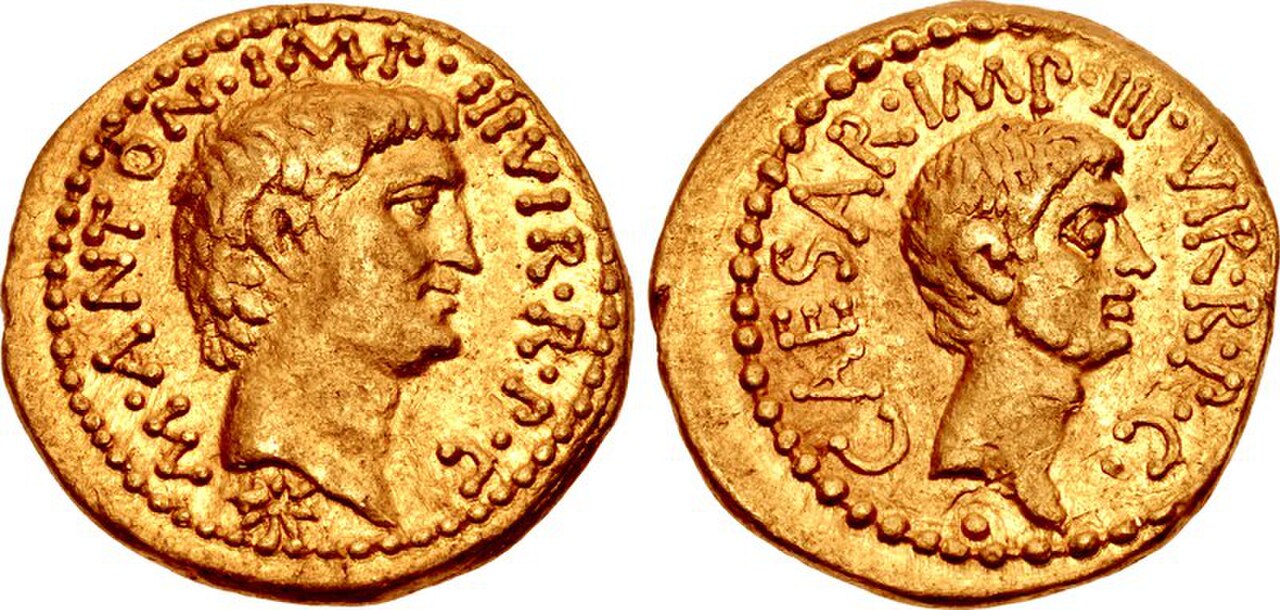 Gold aureus: on the left, bare head of Mark Antony with the legend M ANTON IMP III VIR R P C; on the right, bare head of Octavian with the legend CAESAR IMP III VIR R P C
