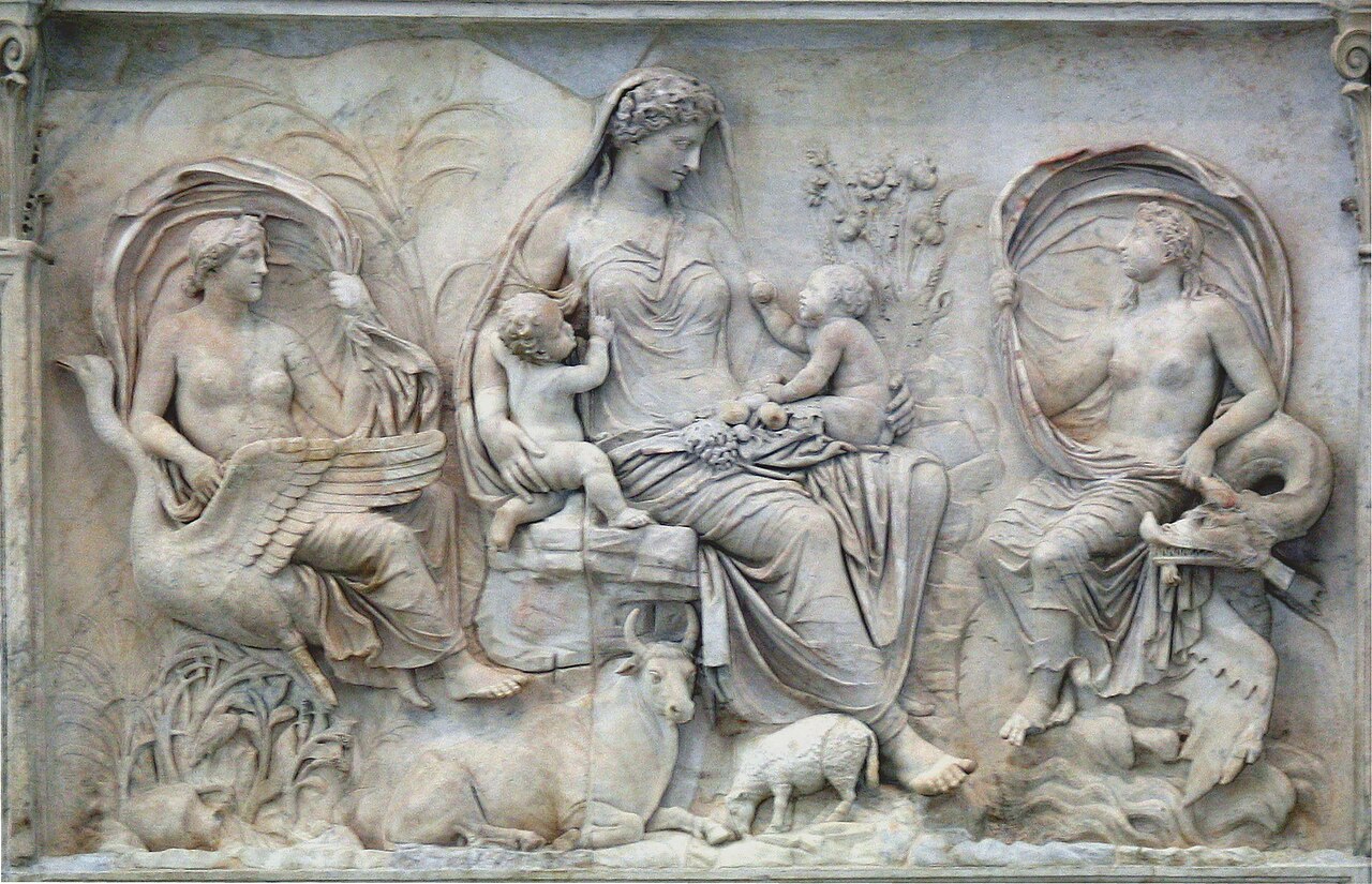 Relief panel from the Ara Pacis: a seated goddess holding two infants, flanked by two female figures riding a swan and a sea-creature, with a cow and a sheep at her feet