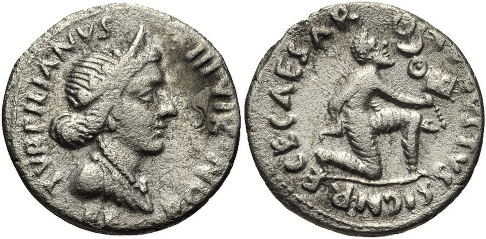 Silver denarius: on the left, the draped head of the goddess Feronia; on the right, a Parthian kneeling and holding out a Roman standard, with the legend CAESAR AVGVSTVS SIGN RECE