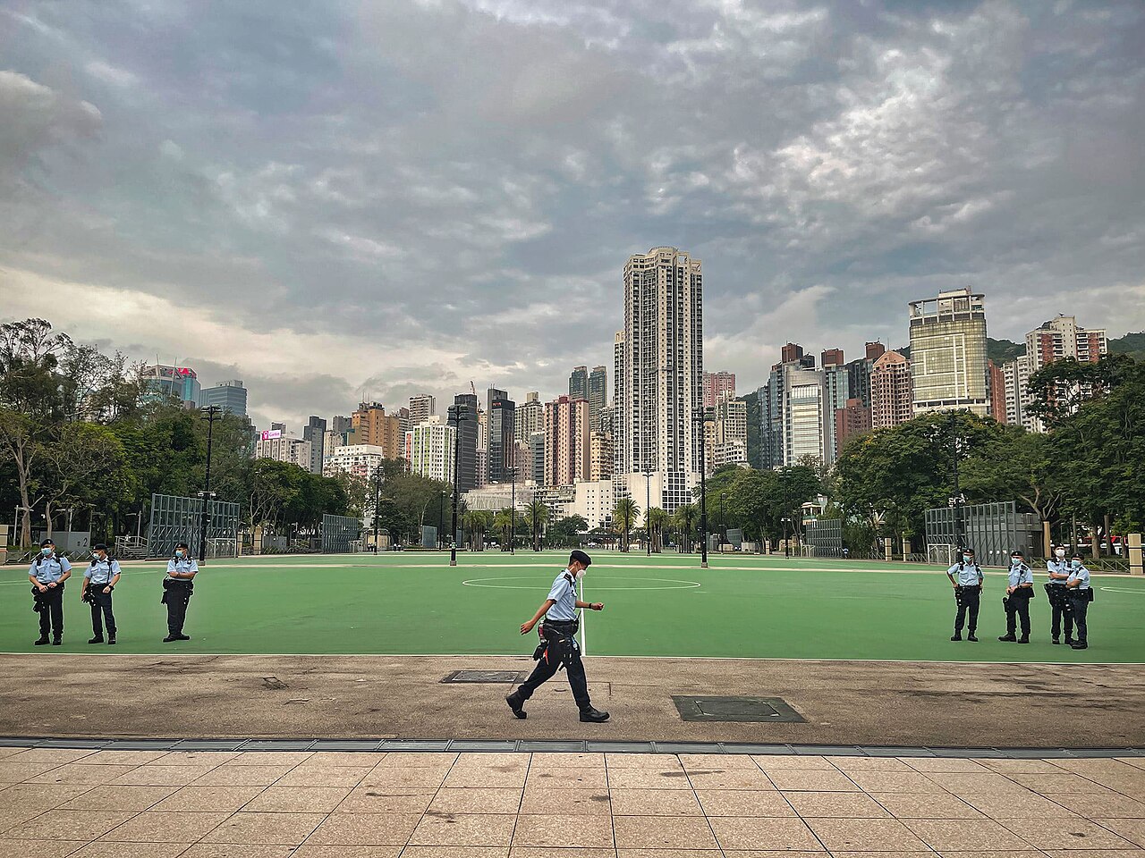Police officers stand along the empty football pitches of Victoria Park, Hong Kong, on 4 June 2021