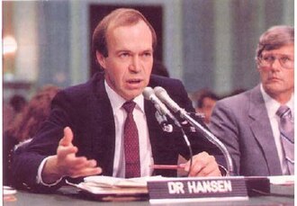 James E. Hansen speaking at a congressional hearing table with a nameplate reading DR HANSEN