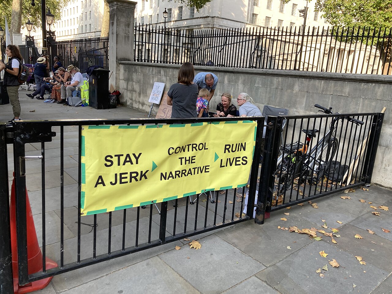Banner reading "Stay a jerk, Control the narrative, Ruin lives" on Whitehall, London, September 2020