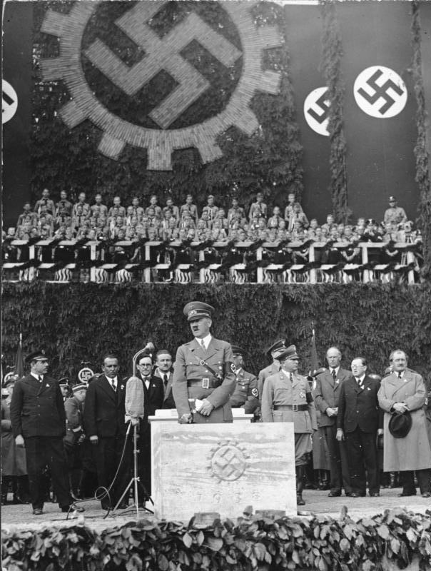 Hitler laying the foundation stone of the KdF-Wagen factory at Fallersleben, 26 May 1938, with Ferdinand Porsche at right