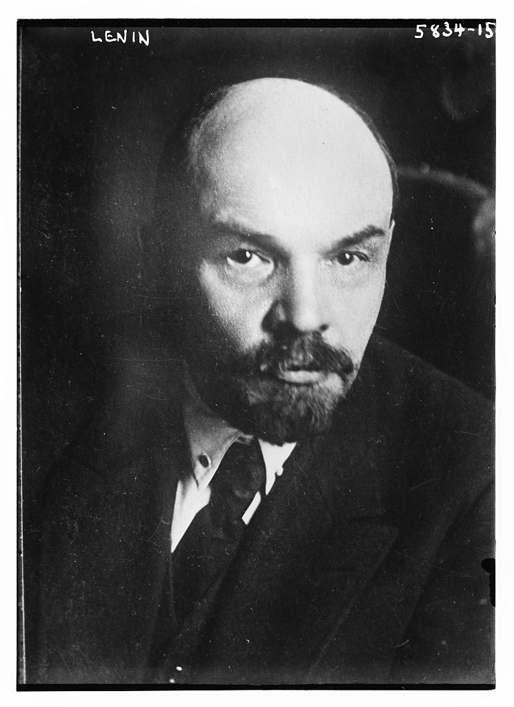 Head-and-shoulders portrait photograph of Lenin in a suit and tie, looking at the camera