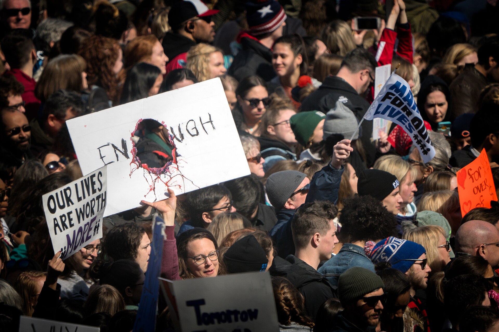 Crowd with signs reading "Enough" and "Our lives are worth more" at March for Our Lives, Washington, 24 March 2018