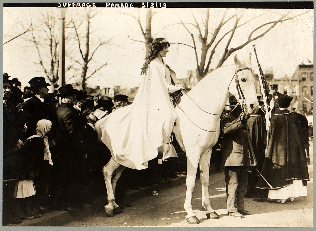 Inez Milholland in a white cape on a white horse leading the suffrage procession, Washington, 3 March 1913