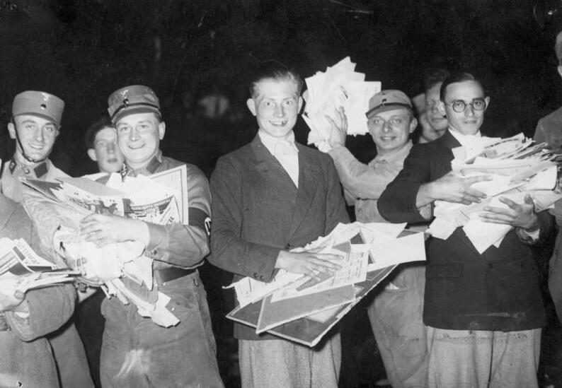 Students and SA men holding books and papers at the burning site on the Opernplatz, Berlin, 10 May 1933