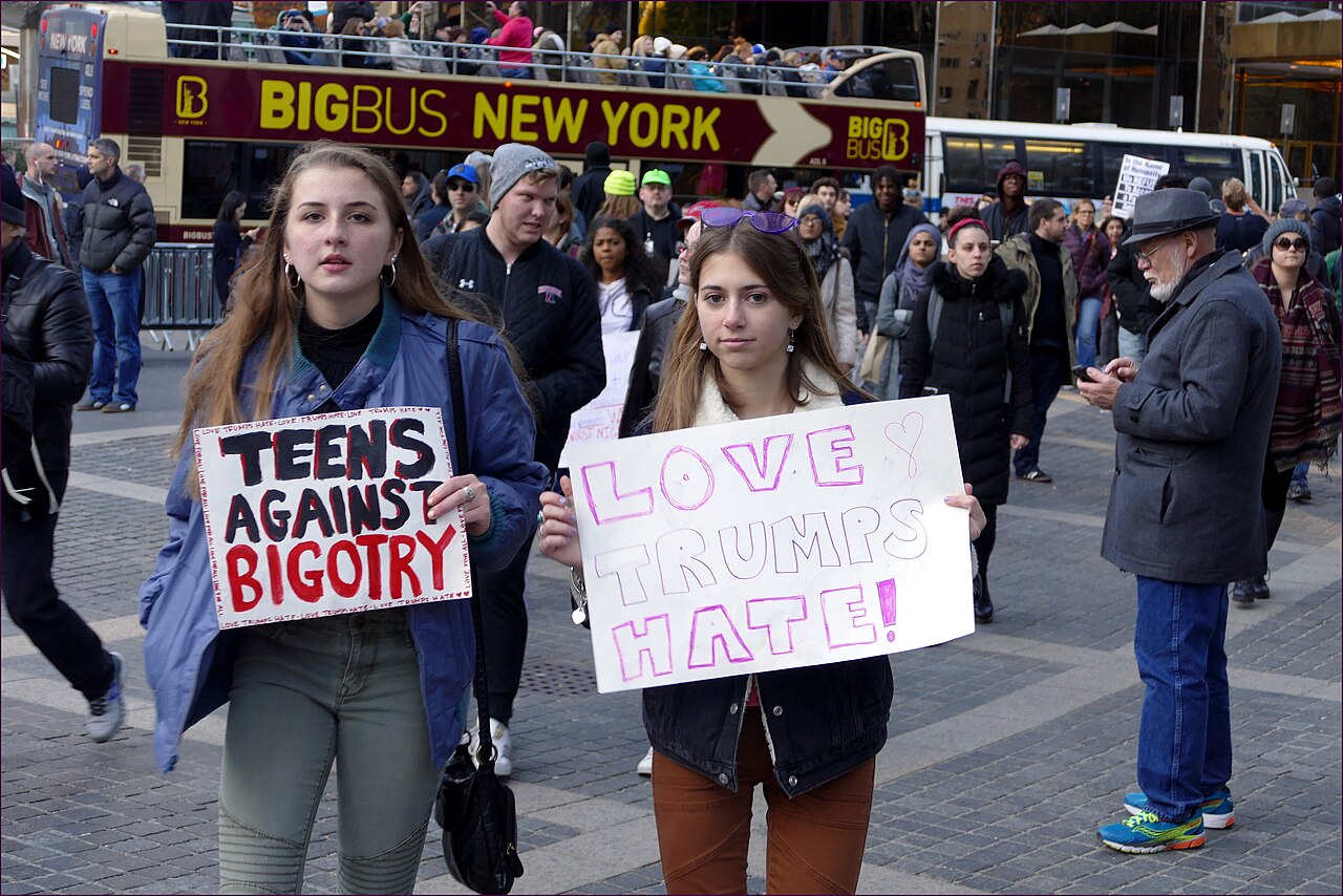 Two marchers in Union Square, New York, hold signs reading "Teens Against Bigotry" and "Love Trumps Hate!"