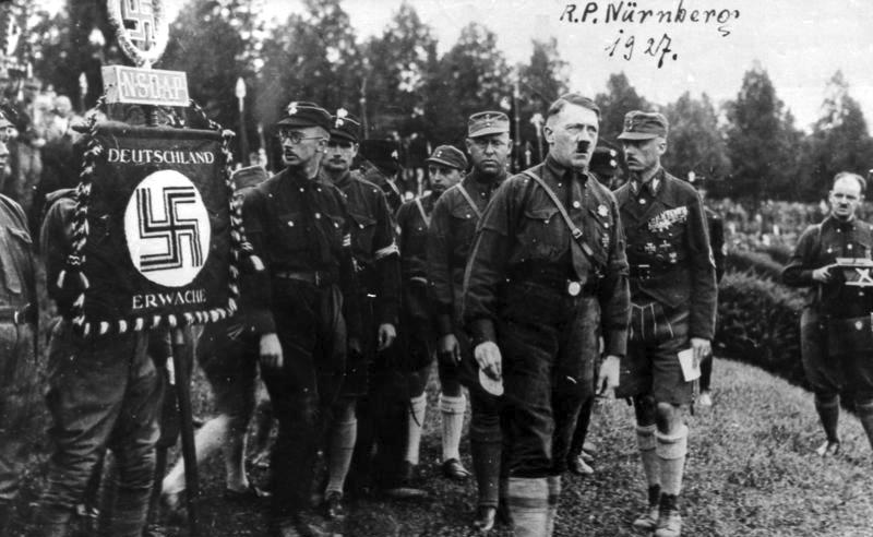 Hitler with SA and party leaders marching behind a "Deutschland Erwache" (Germany Awake) standard at the Nuremberg rally, August 1927