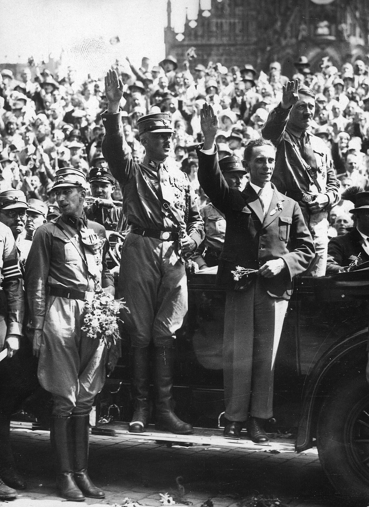 Adolf Hitler, Joseph Goebbels and SA commander Franz Pfeffer von Salomon salute a crowd from an open car at the Nuremberg rally, August 1929