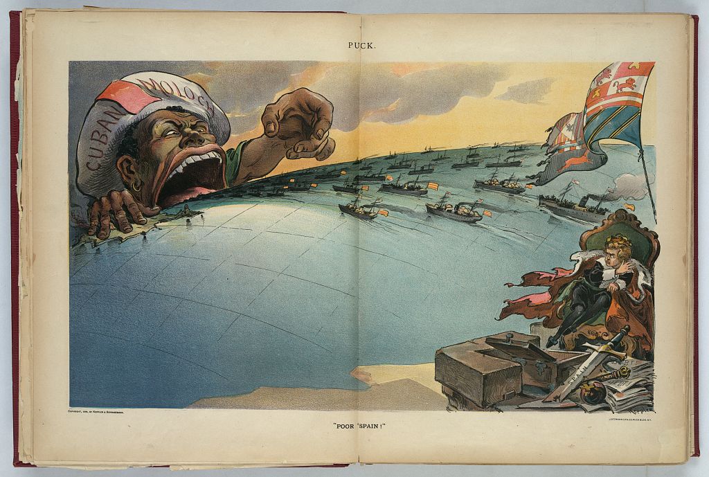 Puck cartoon Poor Spain: a giant Black figure in a cap labelled Cuban Moloch reaches over the globe as ships carry Spanish troops toward him, while a boy king sits beside empty treasure chests