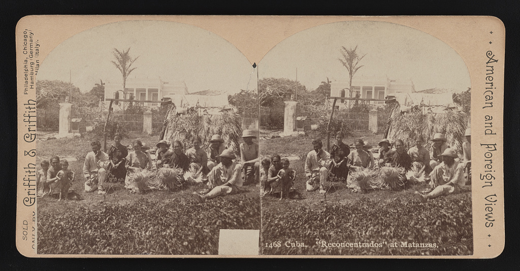 Stereograph of a group of Cuban reconcentrados, adults and children, seated outdoors