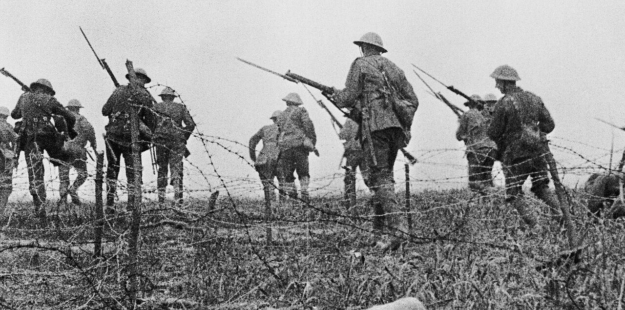 Staged attack sequence from The Battle of the Somme (1916): British soldiers advancing through barbed wire