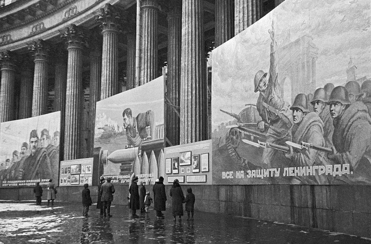 Painted placards on the colonnade of the Kazan Cathedral in Leningrad, October 1941; the one on the right reads "Everyone to the defence of Leningrad!"