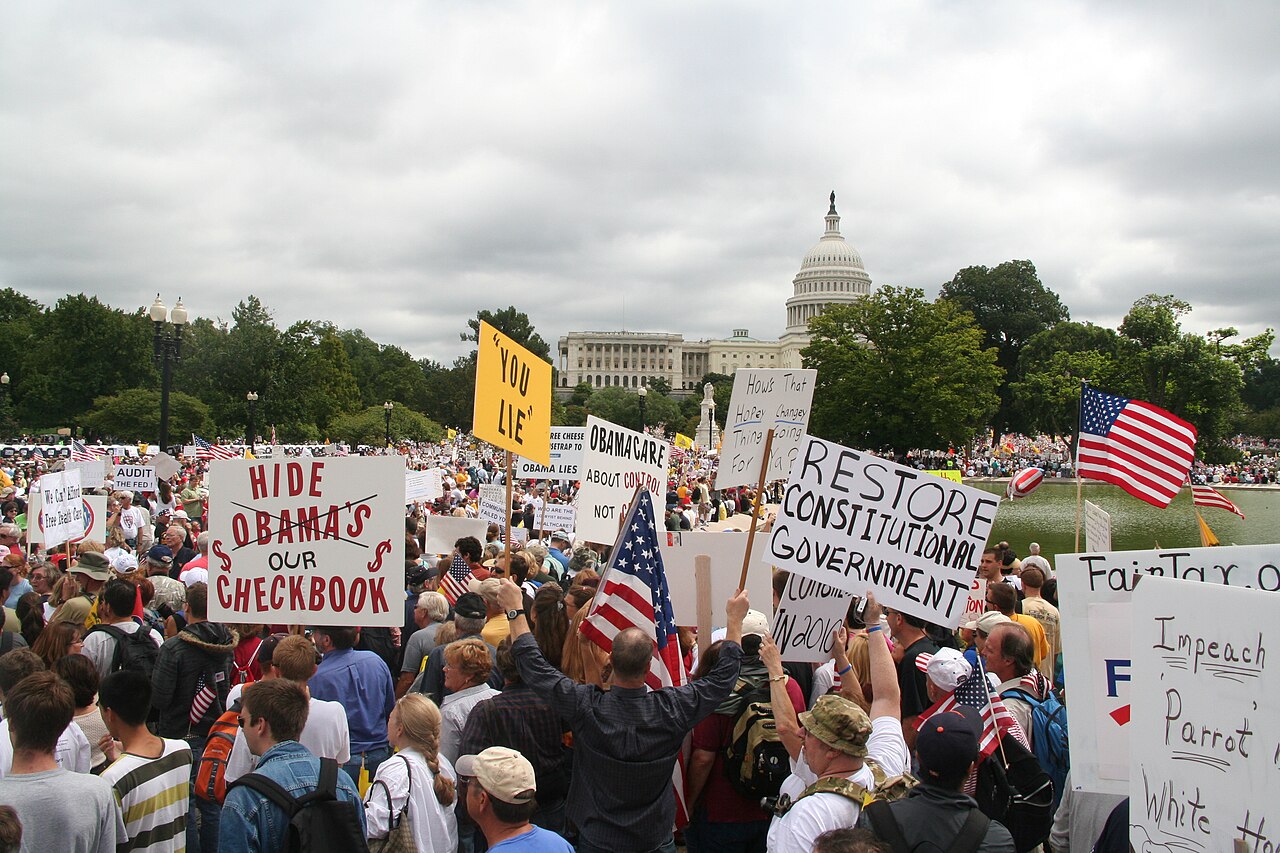 Tea Party protesters with signs near the U.S. Capitol at the Taxpayer March on Washington, 12 September 2009