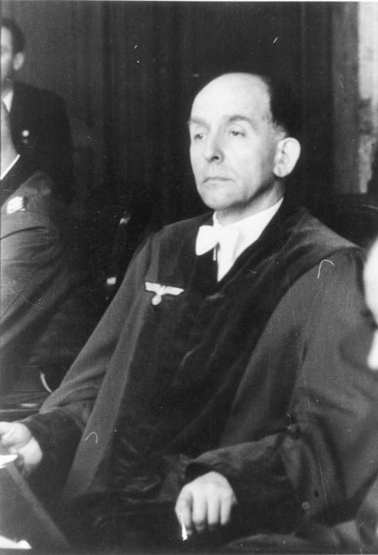Roland Freisler, president of the Volksgerichtshof, seated in judicial robe, 1944