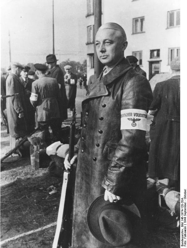 An older man in civilian clothes wearing a "Deutscher Volkssturm" armband