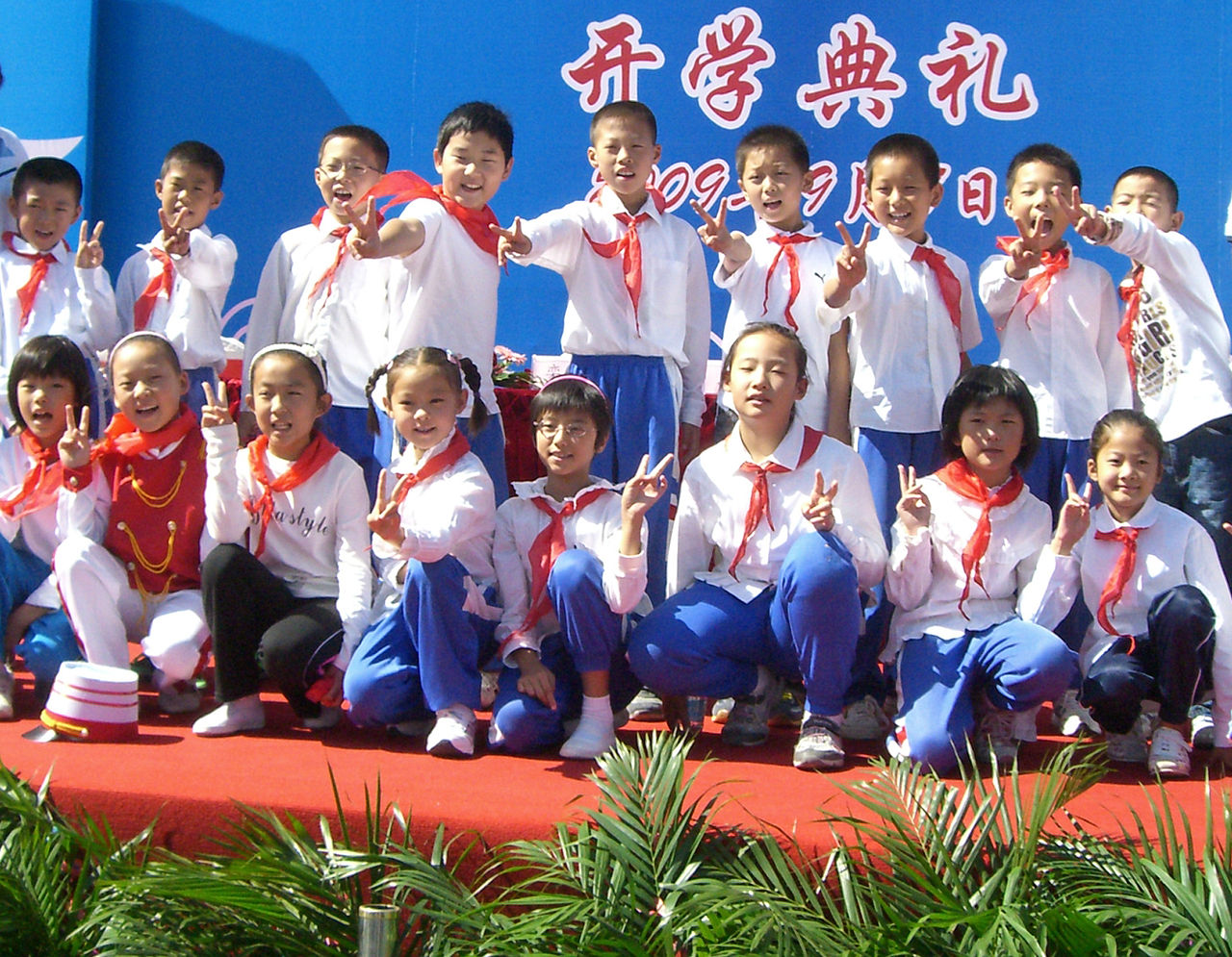 Young Pioneers in white shirts and red scarves posing at a school opening ceremony, Beijing area, 1 September 2009