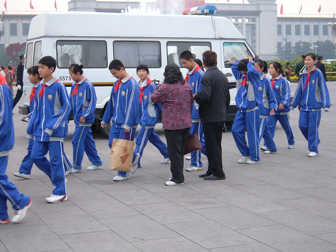 Schoolchildren in blue tracksuits and red scarves walking in Tiananmen Square, Beijing, 23 October 2007