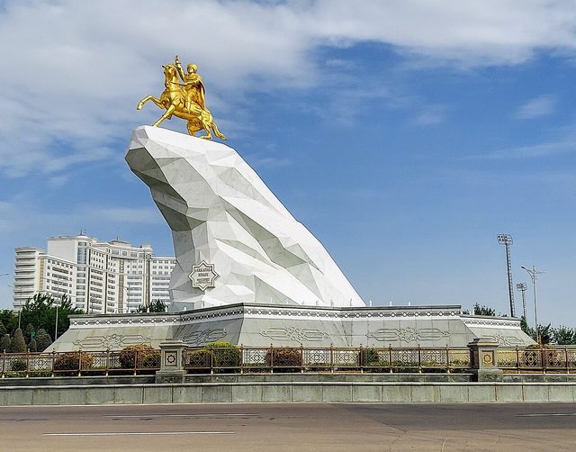 Golden equestrian statue of Gurbanguly Berdimuhamedov on a white-marble cliff, Ashgabat