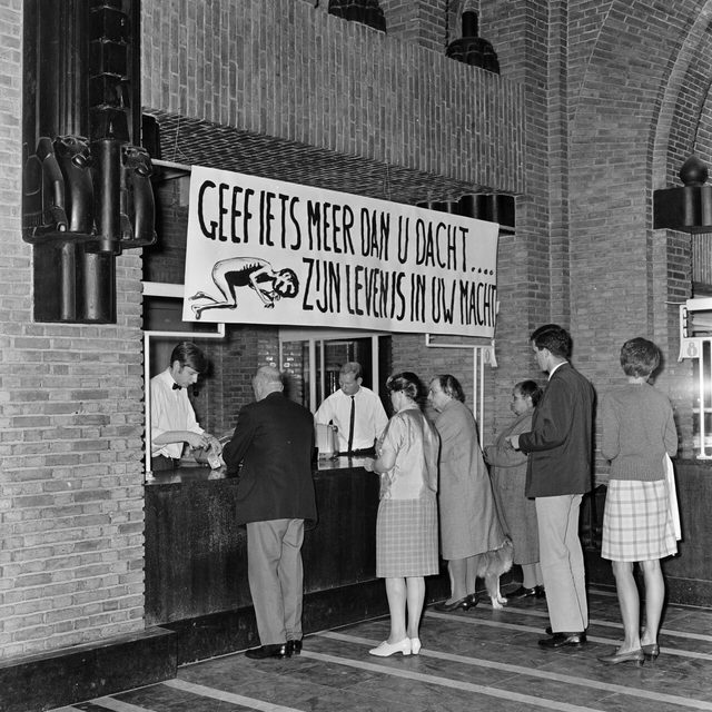 Biafra famine-relief banner above a post office counter, Utrecht