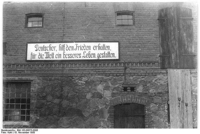 'Deutscher, hilf den Frieden erhalten' (German, help preserve peace): banner on a state farm, Petkus, East Germany