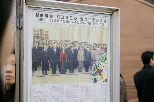Newspaper page on a Pyongyang Metro reading stand: Kim Jong-un at Kumsusan Palace of the Sun, New Year 2017 (photographed 2017)