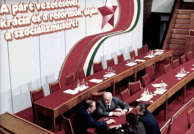 Stage slogan at the MSZMP national conference, Budapest: "A párt vezetésével, [de]mokrácia és a reformok útján a szocializmusért!"