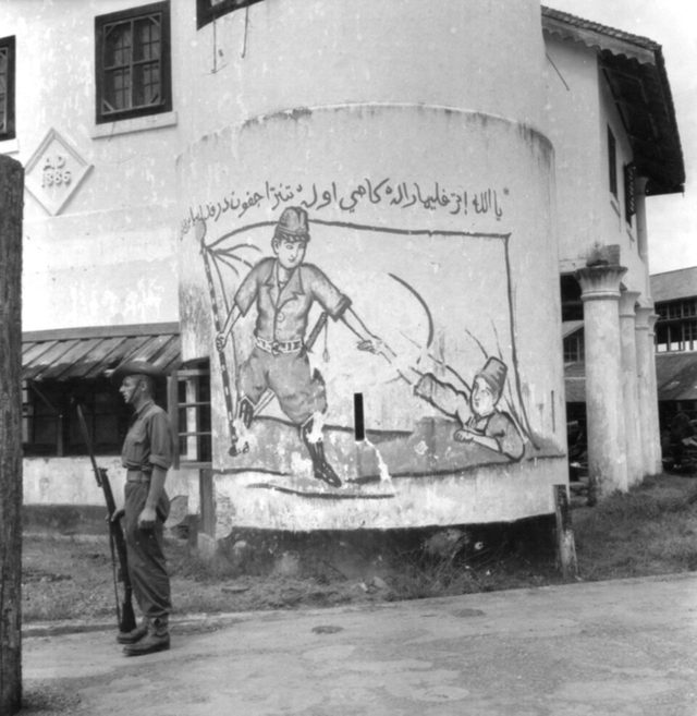 Painted wall sign with Jawi inscription and Japanese soldier, Kuching, Sarawak (photographed 14 September 1945)