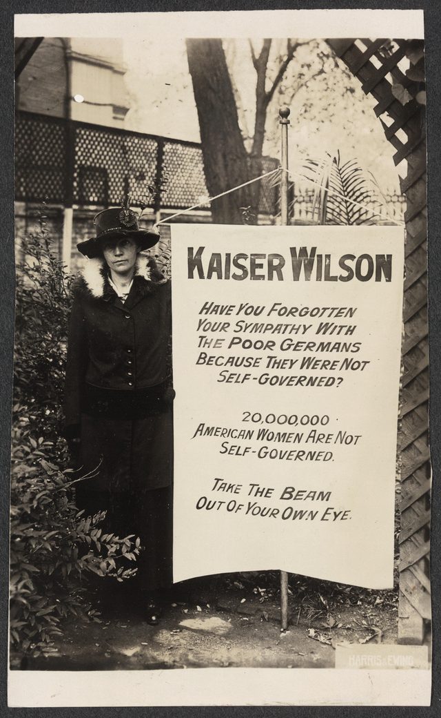 Virginia Arnold [holding Kaiser Wilson banner]
