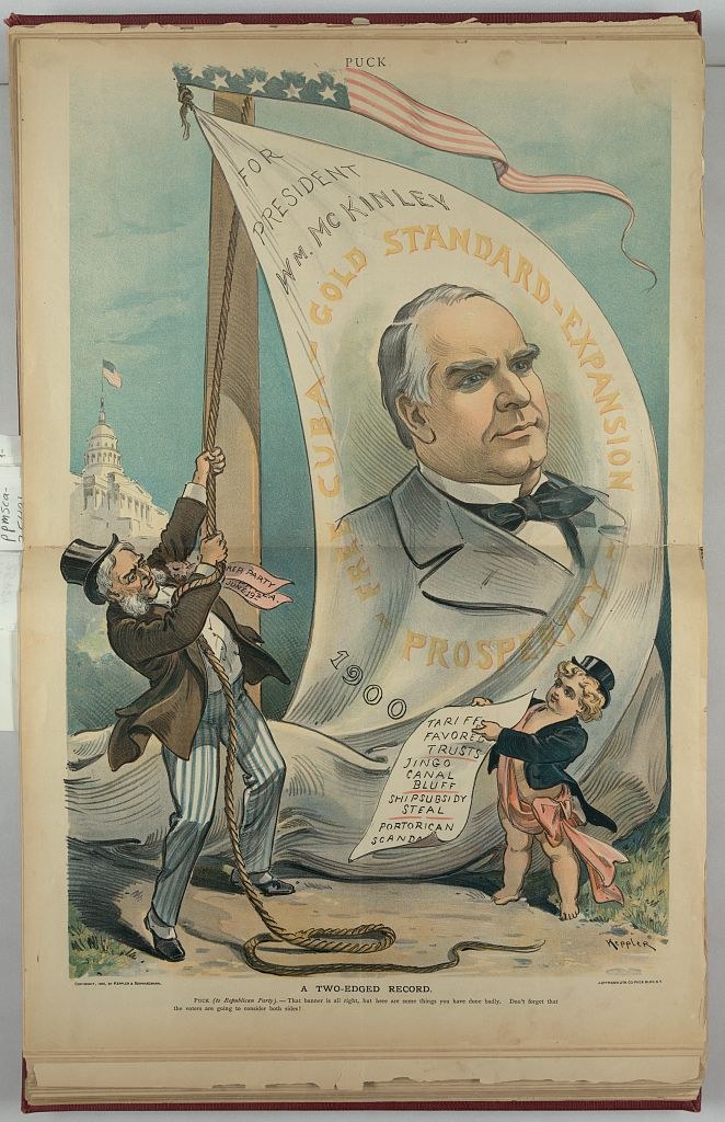 Puck cartoon with a figure raising a banner For President McKinley while a child Puck holds a list of tariff, canal, ship subsidy and Porto Rico charges