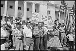 Crowd at the Arkansas State Capitol protesting school integration, with signs reading "Race mixing is Communism," Little Rock, Arkansas