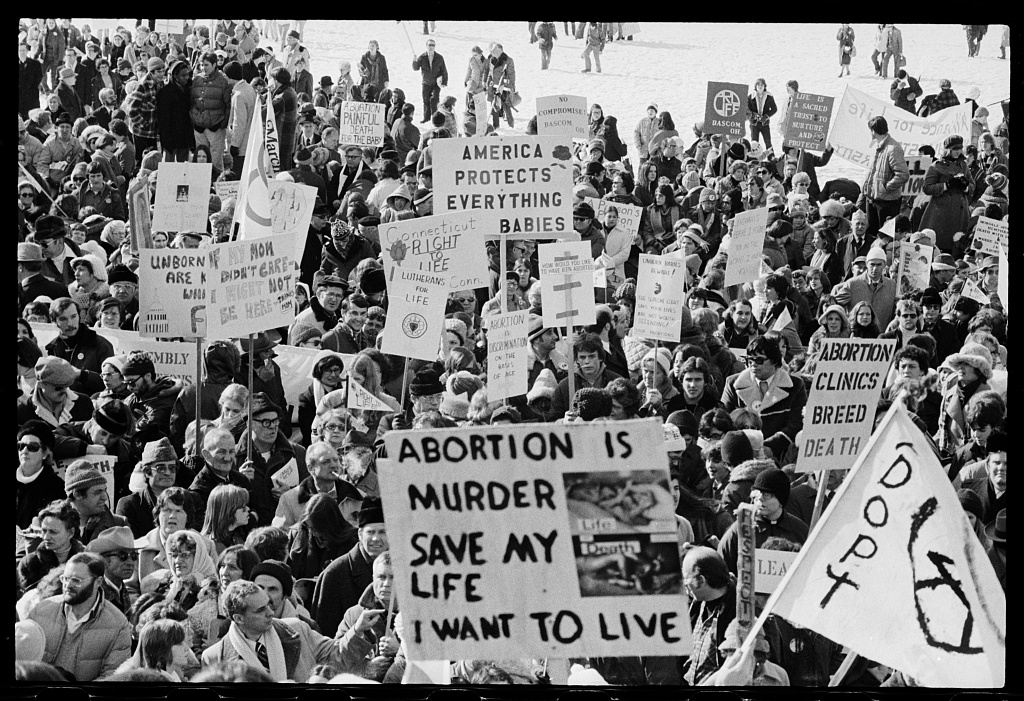 Marchers at the 1978 March for Life carrying hand-lettered signs including "Abortion is murder"