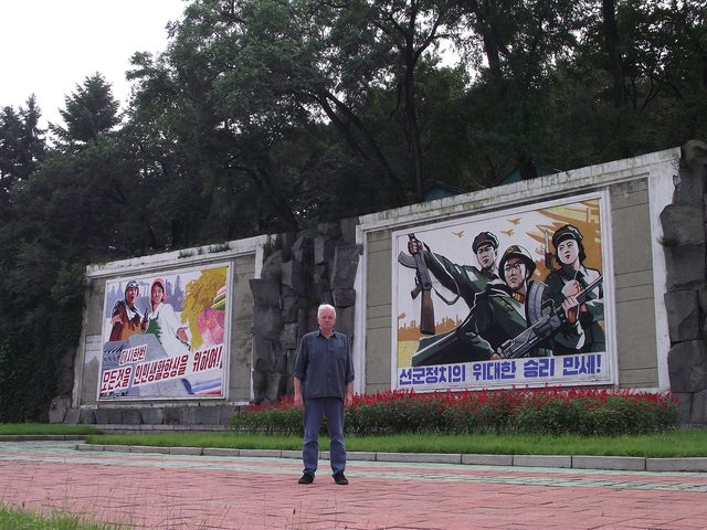 "선군정치의 위대한 승리 만세!": paired roadside murals (photographed 2011)