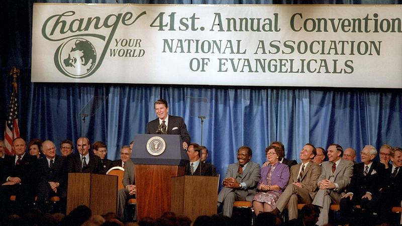 President Reagan speaking at a lectern under the banner of the 41st annual convention of the National Association of Evangelicals
