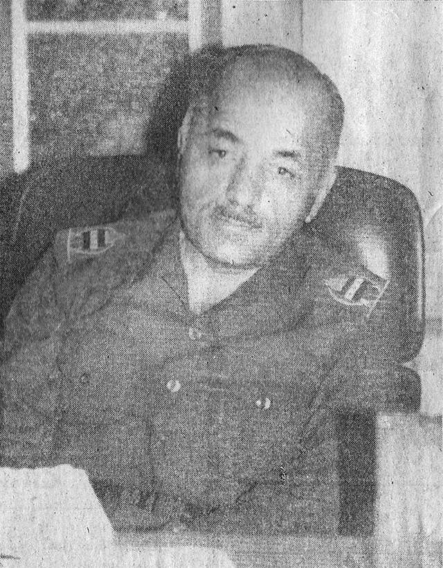 Taha Yassin Ramadan in military dress at a desk, in a 1988 newspaper photograph