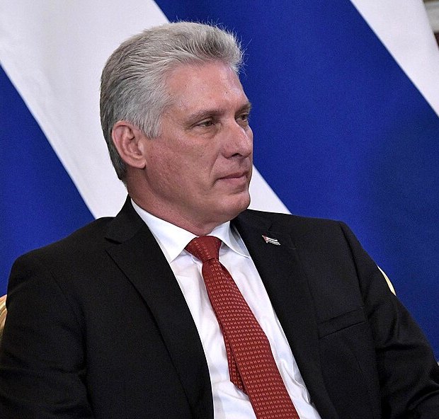 Miguel Díaz-Canel seated in profile before a Cuban flag, 2 November 2018