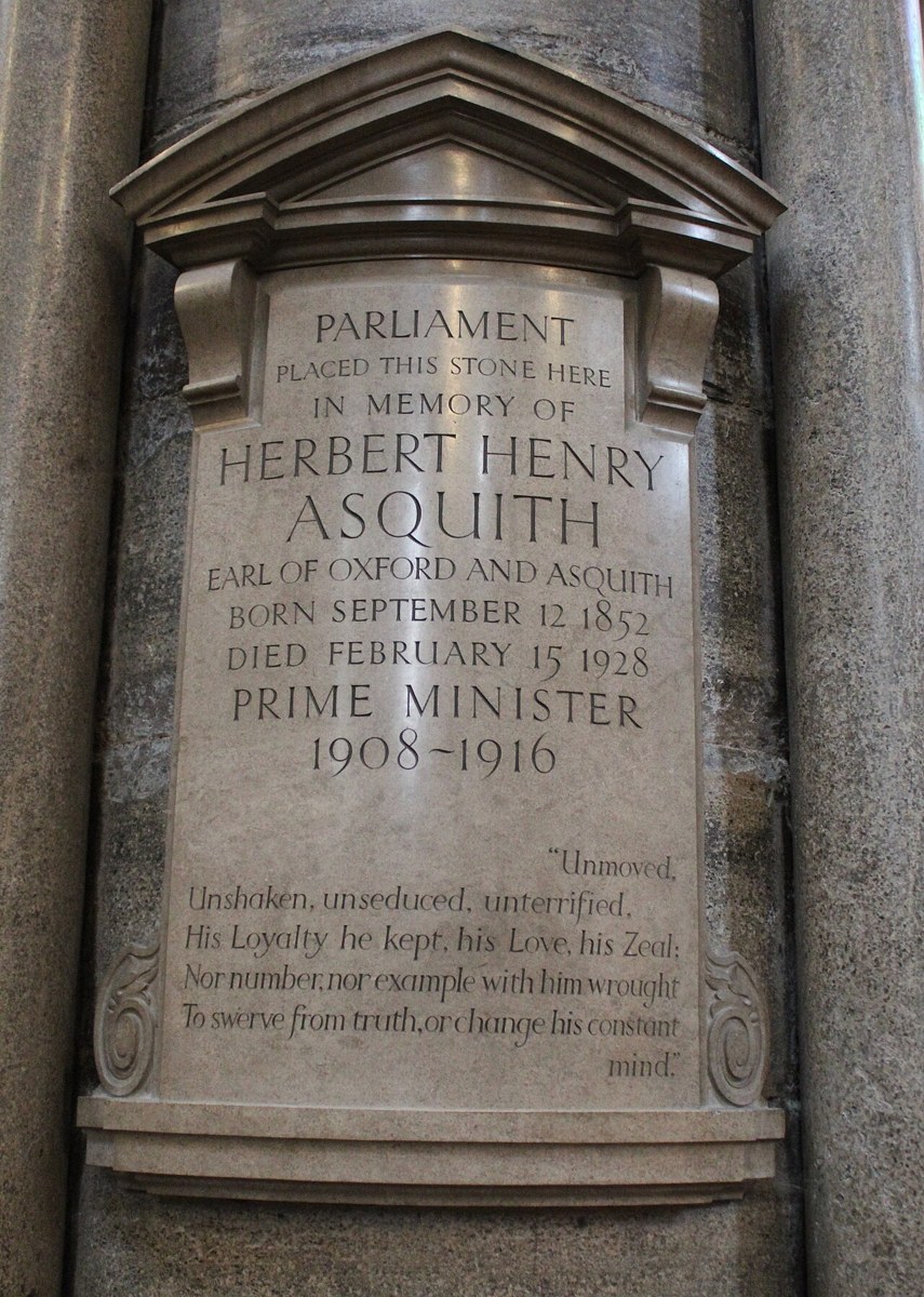 A pale stone memorial tablet on a column, headed Parliament placed this stone here in memory of Herbert Henry Asquith, with four lines of verse at the foot
