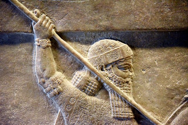 Detail of a lion-hunt relief from Nineveh in the British Museum showing the king in profile with a spear