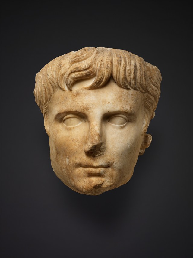 Marble head of Augustus, the nose damaged, against a dark ground