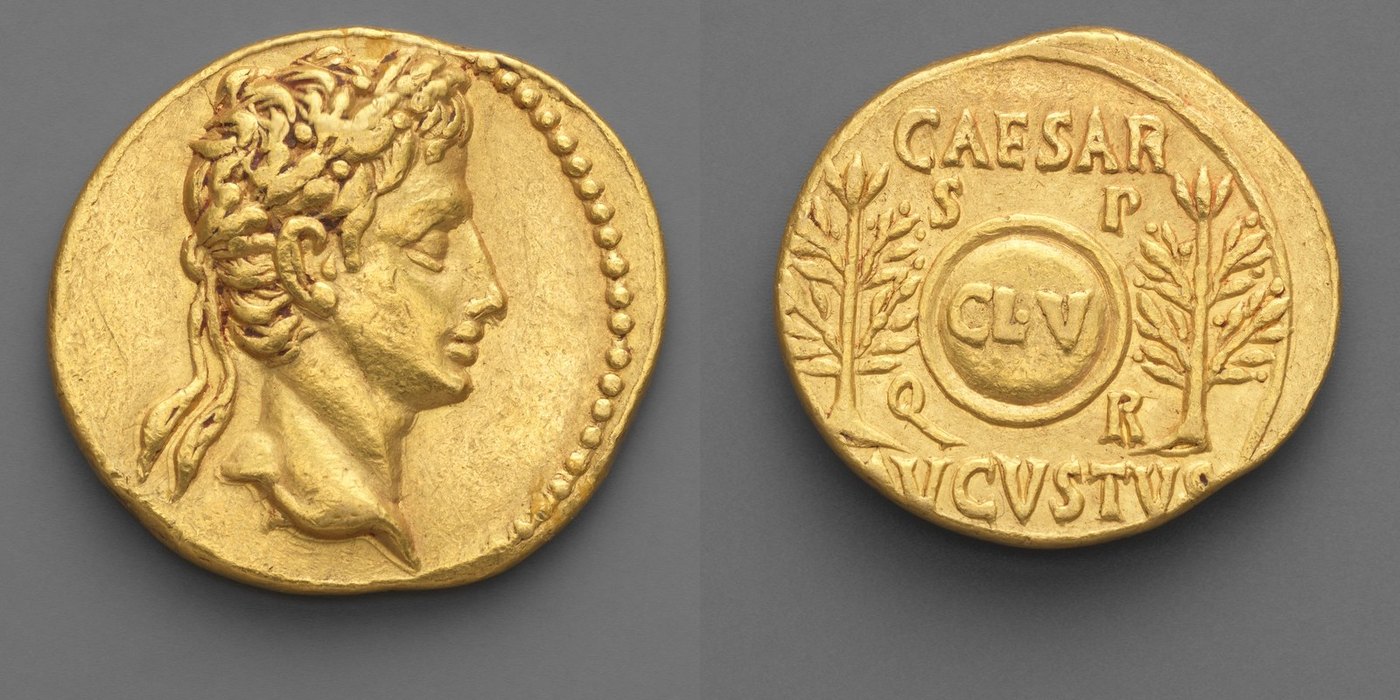 A gold coin shown front and back: a laureate head facing right, and a round shield marked CL V between two laurel trees with the letters S P Q R and CAESAR AVGVSTVS around it