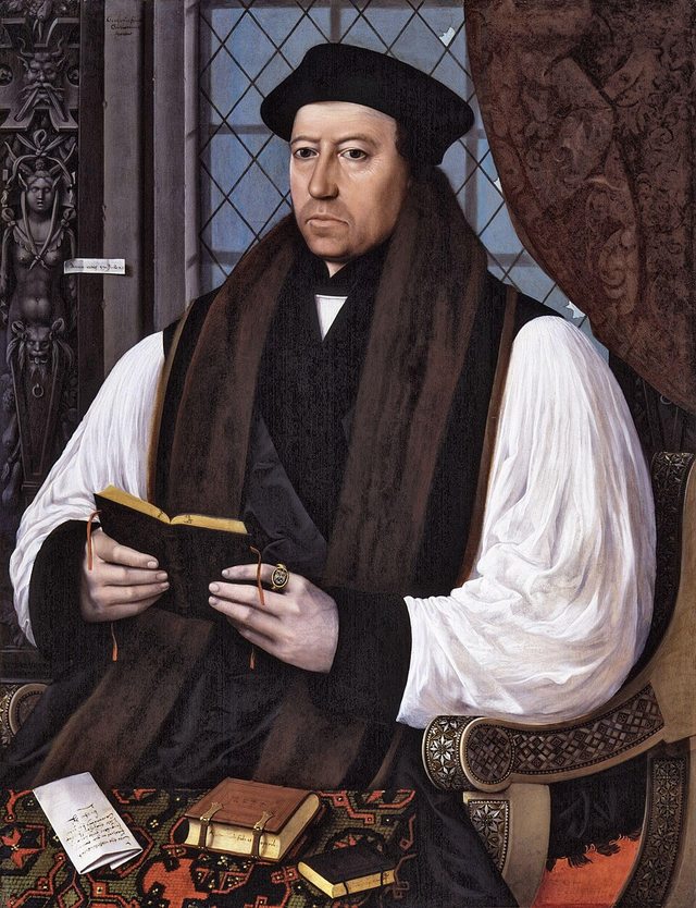 Thomas Cranmer in a black gown and cap, bearded, seated, in a half-length portrait