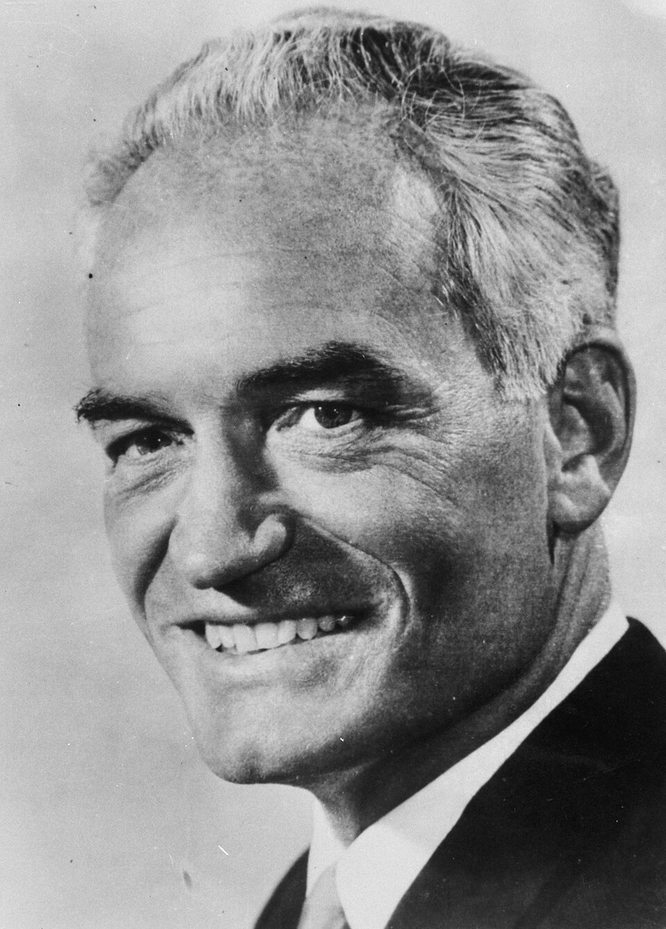 Black-and-white news-agency portrait of Senator Barry Goldwater smiling, head and shoulders