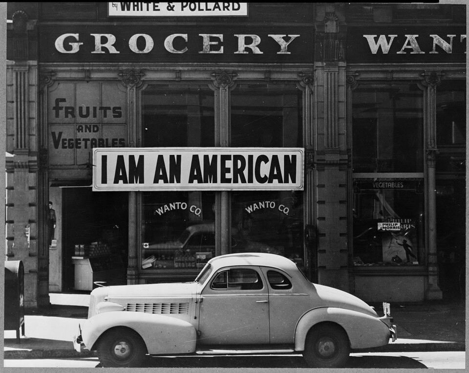 Store window in Oakland with a large sign reading "I am an American", March 1942
