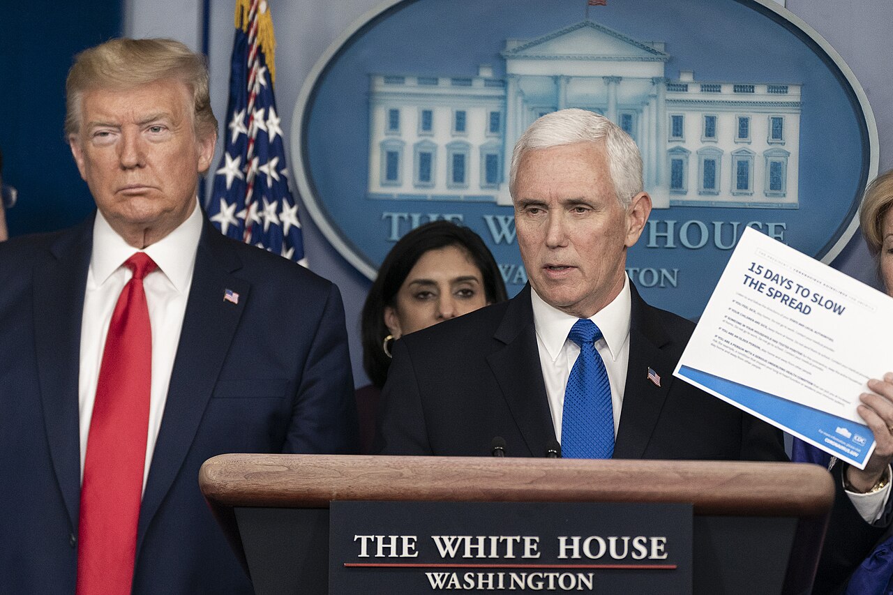 Vice President Pence speaking at the coronavirus task force briefing of 18 March 2020, with President Trump standing at left